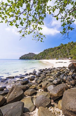 Rock on white beach, the sea and beautiful cloudsの写真素材