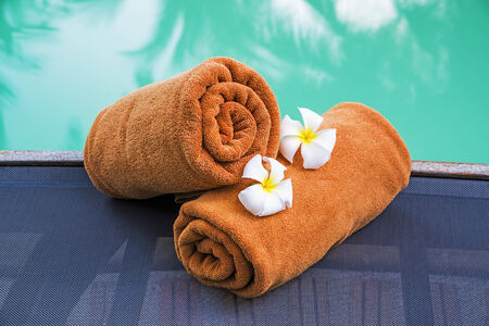 Rolled towels near the outdoor swimming pool の写真素材