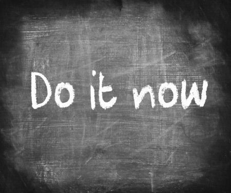 Do it now  -writing on chalkboardの写真素材