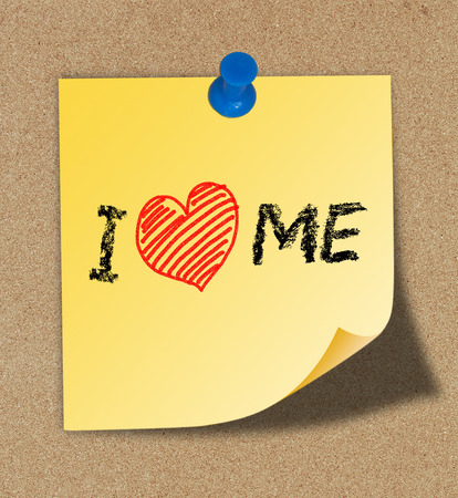 I Love Me writing on yellow note pinned on cork board background の写真素材