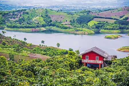Red wooden cabins at campsite on lake, Thailandのeditorial素材