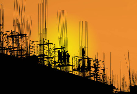 Silhouette workers on scaffolding steel in sunset background