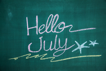 Hello july written on blackboardの写真素材
