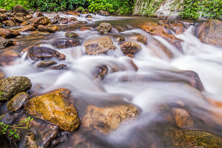 Water flowing over rocks in a creek. の写真素材
