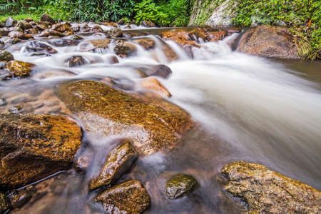 Water flowing over rocks in a creek. の写真素材