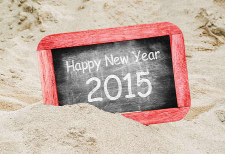 Happy New Year 2015, handwritten with white chalk on a blackboardの写真素材