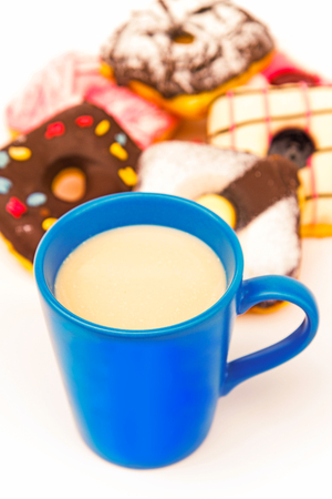 Milk in a mug with donuts served for boy.の写真素材
