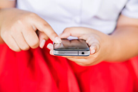 Young woman using a touchscreen smartphone.の写真素材