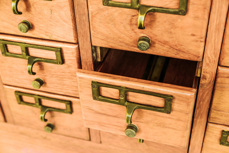 Old wooden drawers with one opened.の写真素材