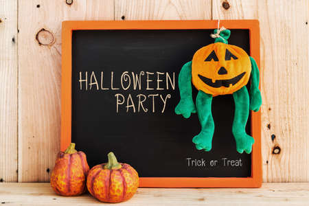 Halloween Party written on chalkboard against wooden wallの写真素材