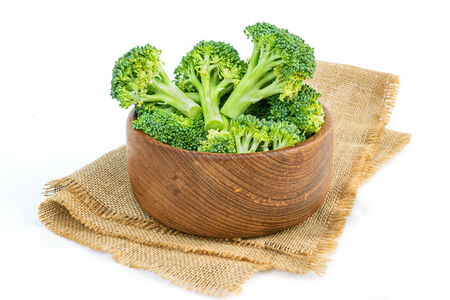 Broccoli head in wooden bowl on sackcloth.の写真素材