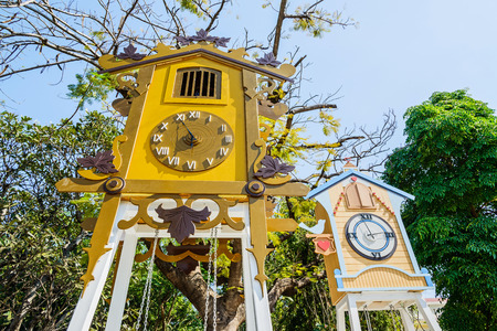 Swings hanging from clock houses.の写真素材