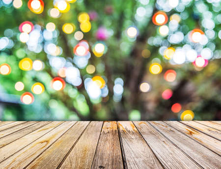 Perspective View to Lights blurred bokeh of big tree background and wooden floor texture in the...