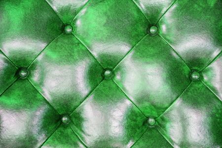 Green leather upholstery sofa background for decoration.の写真素材