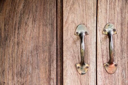 Rustic wooden doors background with old handlesの写真素材