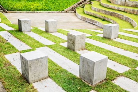 Seating and stairway with green grass in parkの写真素材
