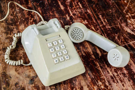 Retro rotary telephone on wood tableの写真素材