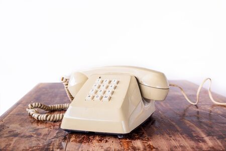 Retro rotary telephone on wood table.の写真素材