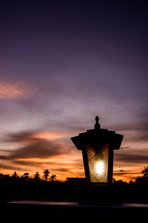 Black silhouette of lamp in sunsetの写真素材