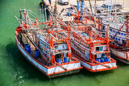 Thai wooden fishing boats in harbor, Thailand