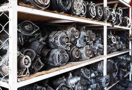 Old car alternators on shelf.の写真素材