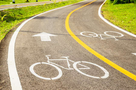 Bicycle sign on bicycle lane in morning sunshine. The main focus is at the symbol.