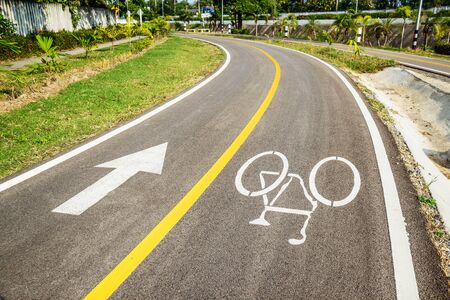 Bicycle sign on bicycle lane in morning sunshine. The main focus is at the symbol.の写真素材