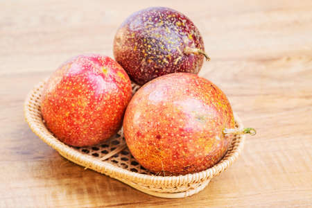Fresh passion fruit isolated on wooden backgroundの写真素材