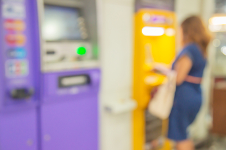 Blurred image of atm machines and woman at airportの写真素材