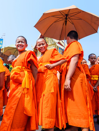 CHIANG MAI THAILAND - APRIL 13, 2016 : Buddhist young novice monks walking at Wat Phra Singh Temple in Chiangmai Songkran festival, Parade cars for pour water around the city.のeditorial素材