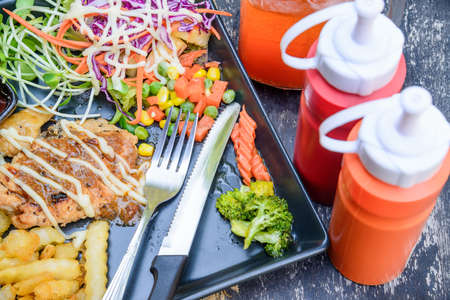 Grilled Chicken Steaks and vegetable salad with ice lemon tea.の写真素材