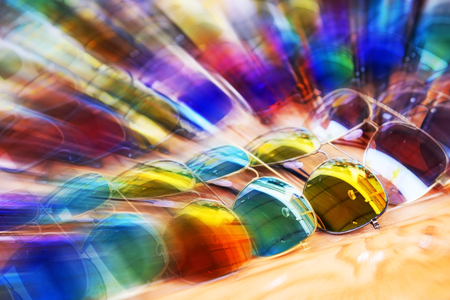 Blurred sunglasses on wood table, use for background.の写真素材