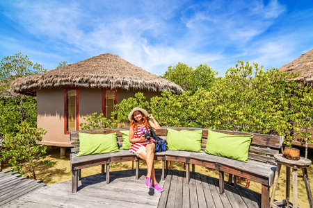 Beautiful women smiling with camera in hand at romantic island, Payam Island, Ranong Province, Thailand.のeditorial素材
