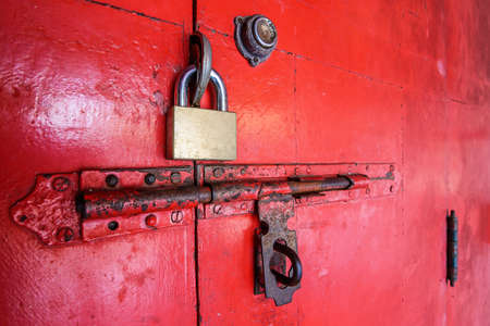 Closeup red wooden door with lockの写真素材