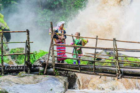 Grandmother and granddaughter at Pha Dok Xu waterfall or Rakjang waterfall on July 30, 2016, Chiang Mai, Thailandのeditorial素材