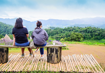 Tourists sitting on wooden bench  with relaxing at view point on Mae Cheam hilltopの写真素材