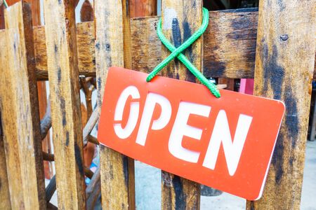Open sign hanging on fence at the shopの写真素材