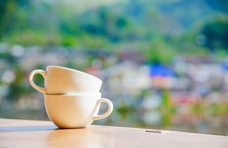 Empty coffee cup on wood table with blur background.の写真素材