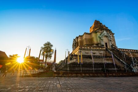 Sunset at Wat Chedi Luang Temple with blue sky and lens flare: Chiang mai Province, Thailand.のeditorial素材