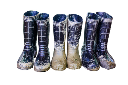 Muddy rubber boots on white background, with Clipping Path.の写真素材