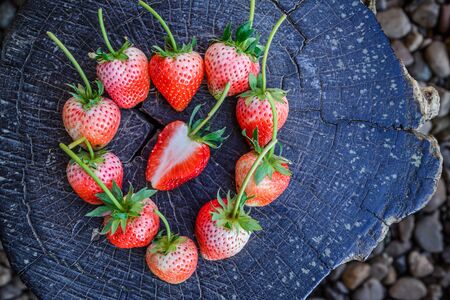 Strawberries arrange as heart shape on tree stump,  Valentine's Day Concept.の写真素材