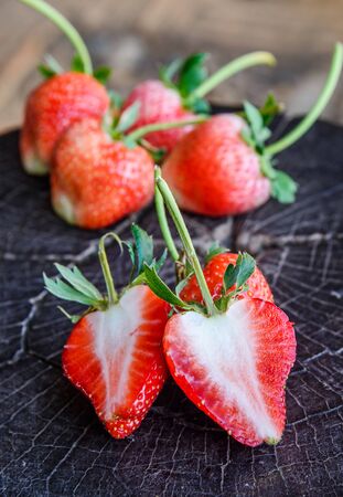 Half of Strawberry, Fresh strawberry, Red strewberry,Strawberry Juice on tree stump.の写真素材