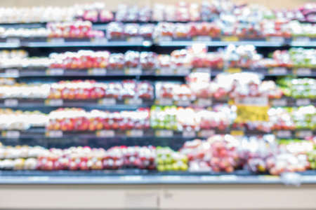 Many different fruits on supermarket shelves blurred backgroundの写真素材