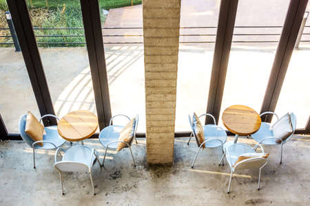 Top view of wooden tables and chairs in coffee shop