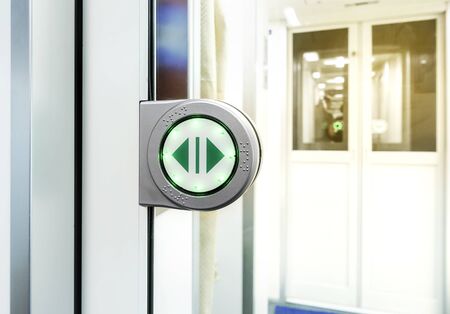 sliding automatic door with buttons on a modern train.