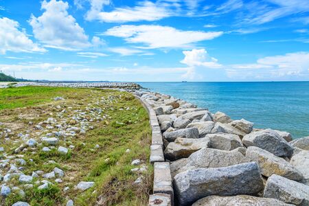 Stone wave breaker into the seaの写真素材