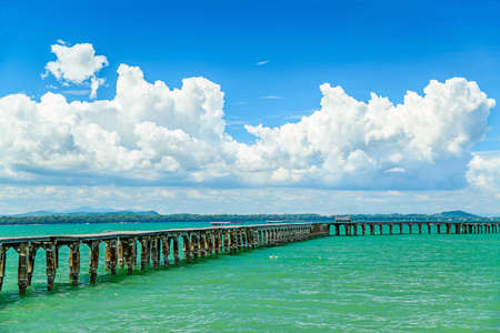 Wooden bridge on the sea with blue skyの写真素材
