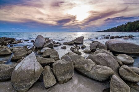 Sunset on the beach at Mae Rumphueng beach , Rayong , Thailand. Long exposure of the wave during sunset on the beach.の写真素材