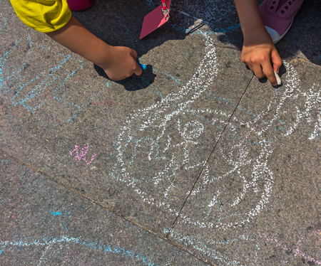 pieces of color chalk on the street floor with drawing on floor.の写真素材