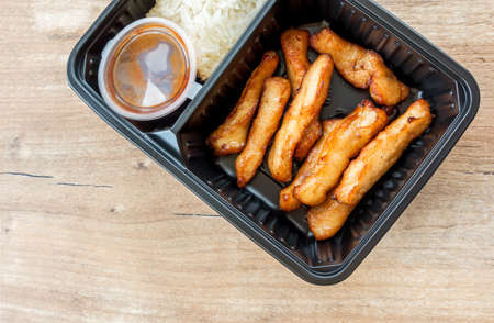 Fried chicken nuggets with sweet chili sauce and sticky rice, selective focusの写真素材